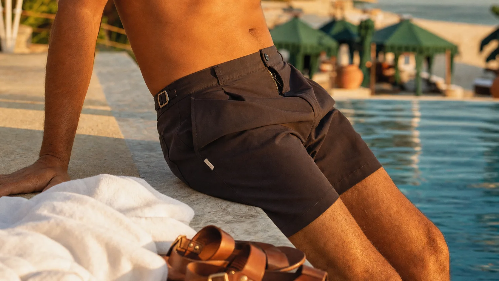 Orlebar brown short de bain tailleur sur rebord de piscine hôtel